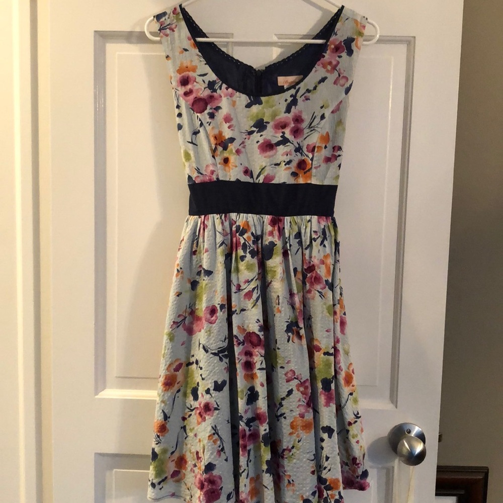 A mid length dress with a flower pattern.